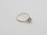 an old cut diamond ring on a white surface