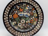 a black plate with a floral design on it