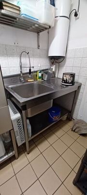 a kitchen with a sink and a refrigerator in it