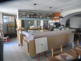 an image of a kitchen and dining room with a bar