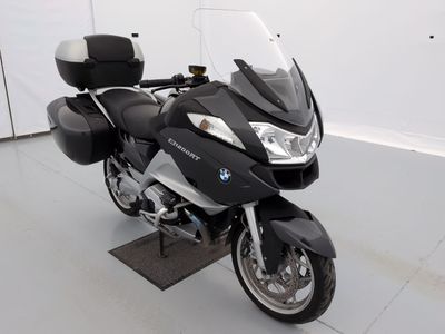 une moto noire et argentée garée dans une pièce blanche