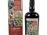 the bottle of caroni is next to a box of wine