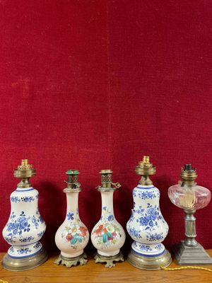 five vases on a table with a red wall in the background