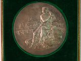 an antique silver plate with a woman sitting on top of a tree