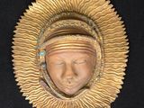 an image of a gold mask on a black background