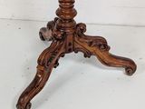 an image of a wooden table with a marble top on a white floor