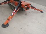 a small crane that is sitting on the side of the road