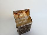 a silver box that is sitting on a white surface
