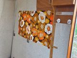 a small bed in the back of a camper with flowers on it