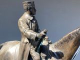 a bronze statue of a man riding a horse