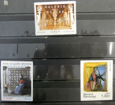 several stamps on display in a glass case in a museum
