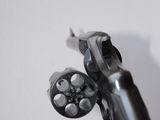 a close up of a gun on a white surface