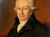 an old painting of a man in a black coat sitting on a red chair