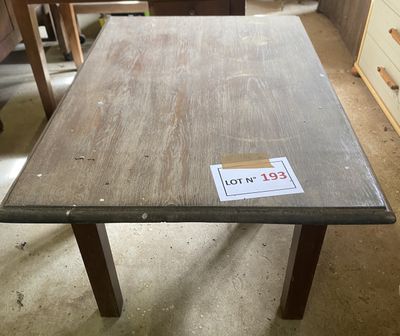 a wooden table with a sticker on it in a room