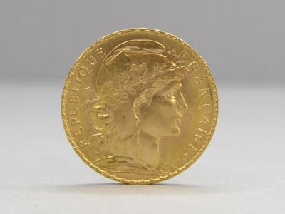 a close up of a gold coin with a woman ' s face on it