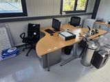 a desk with two computers and a phone on it