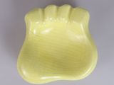 an image of a yellow bowl on a white surface