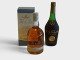 two bottles of alcohol and a box of wine on a white surface
