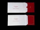 two red and white envelopes with a red ribbon on them