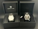 two watches in a box with a tag on each of them