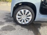 a close up of a car ' s tire with the door open