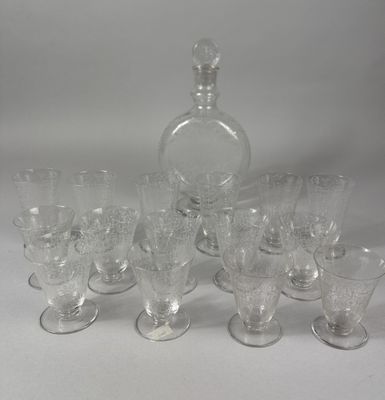 a lot of glasses and a decanter on the table