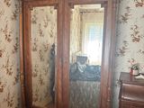 an image of a bedroom with a bed and a large mirror