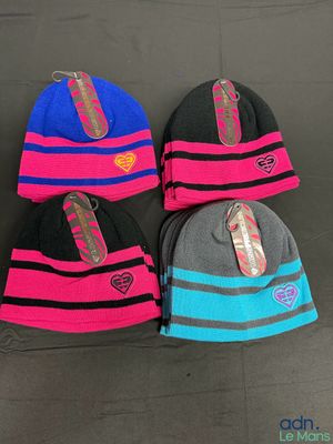 trois chapeaux de couleurs différentes, munis d'étiquettes, posés sur une table