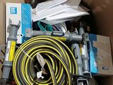 a cardboard box filled with tools and a hose