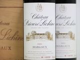 three bottles of wine are lined up on a shelf next to each other