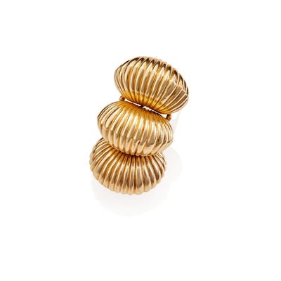 an image of a stack of gold rings on a white surface