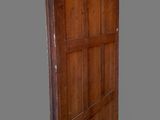 an old wooden door is open on a gray background