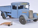 a blue toy truck with a wooden toy car next to it