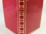 a red book with gold trims and a red cover