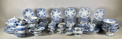 many blue and white dishes and cups on the table