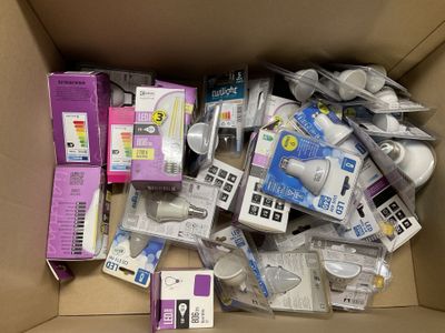 a cardboard box filled with electronic devices and other items