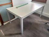 un bureau blanc sur lequel se trouve un rouleau de ruban adhésif vert