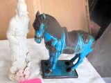 a statue of a man and a horse on a table