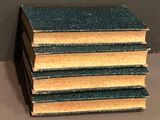 several books stacked on top of each other on a table