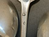 two spoons sitting next to each other on a table