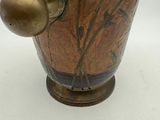 a brown vase with a gold ball on it
