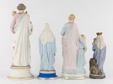 three figurines of jesus, mary, and other figures of people
