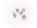 a group of five different colored gems on a white surface