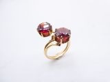 a close up of a ring with two red stones on it