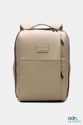 the backpack is beige and has a zipper on the front