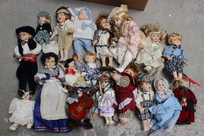 a lot of dolls that are sitting on the floor