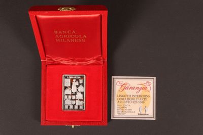 an image of a silver plated medal with a red box