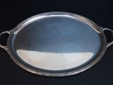 a silver tray with handles on a black table