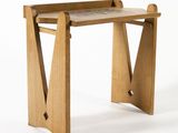 a small wooden table with a marble top on a white background
