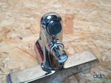 a close up of a faucet on a wooden surface